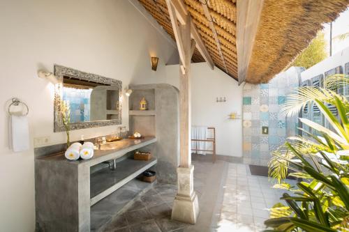 a bathroom with a sink and a mirror at Villa Damai Manis in Seminyak