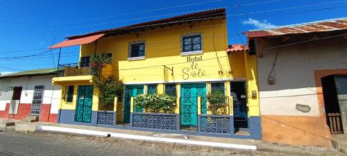 a brightly colored building on the side of a street at Hotel Al Sole in León