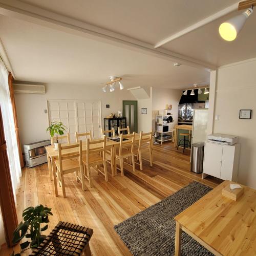 a dining room and kitchen with a table and chairs at Biei Central Villa - Green Garden in Biei