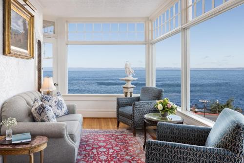 a living room with a view of the ocean at Seven Gables Inn on Monterey Bay, A Kirkwood Collection Hotel in Pacific Grove