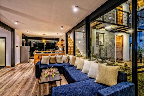 ein Wohnzimmer mit blauen Sofas und einem Tisch in der Unterkunft Dream Cottage Nuwara Eliya in Nuwara Eliya