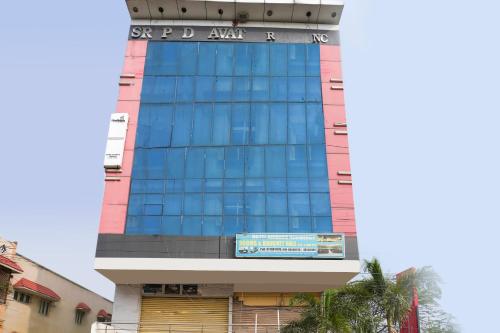 a tall building with blue windows on it at SPOT ON Hotel Sunshine Inn in Hyderabad