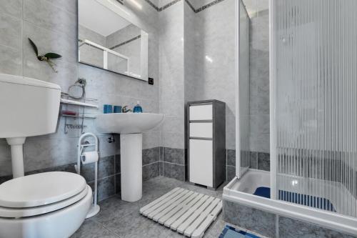 a bathroom with a toilet and a sink and a shower at Room 79-3 in Duće