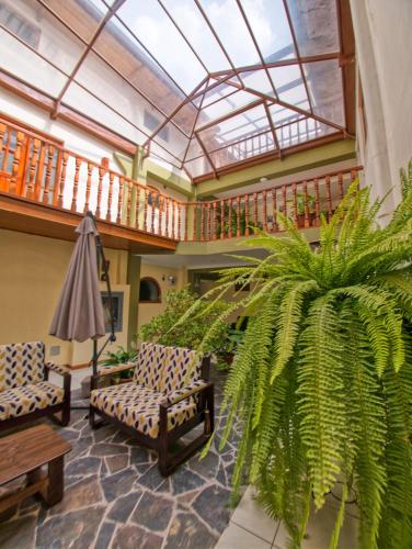 a lobby with two chairs and a plant at Sol Ollantay Boutique Hotel in Ollantaytambo