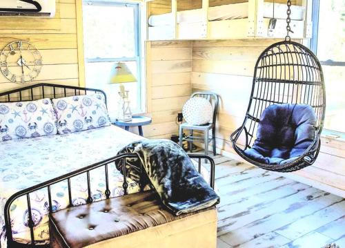 a bedroom with a bed and a swing at Secluded Tiny House by the Marsh with Hunting Island Beach Pass in St. Helena Island