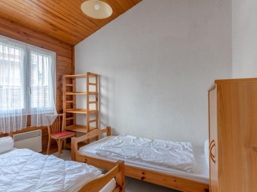 une chambre avec deux lits et une étagère dans l'établissement Maison T3 pour 4 personnes à 400m de la plage et du centre, avec terrasse et parking. - FR-1-521-210, à Biscarrosse
