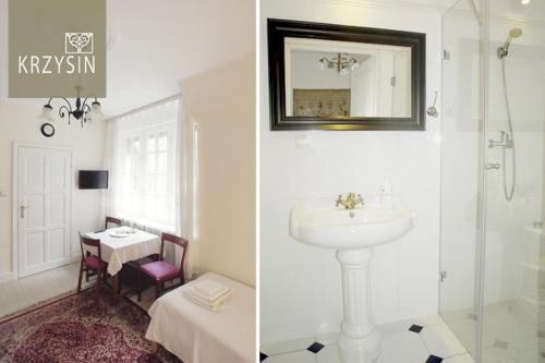 a bathroom with a sink and a mirror and a table at Krzysin in Podkowa Leśna