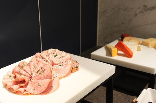 a plate of food sitting on a table with cheese at JN PARK Hotel in Incheon