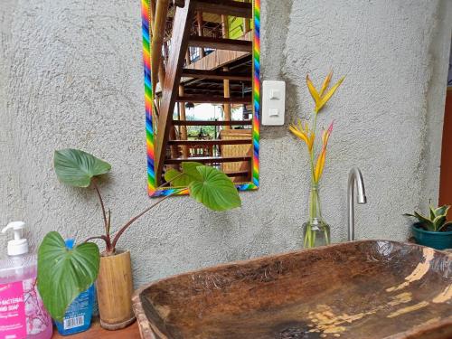 a bathroom with a wooden sink and a mirror at Surf and Skate Duli El Nido By Kiteclub Palawan in El Nido