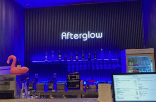 a blue room with a bar with bottles of alcohol at JN PARK Hotel in Incheon