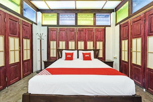 ein Schlafzimmer mit einem großen Bett mit roten Kissen in der Unterkunft OYO Home 90332 Jentayu Homestay Pontian in Pontian Kecil