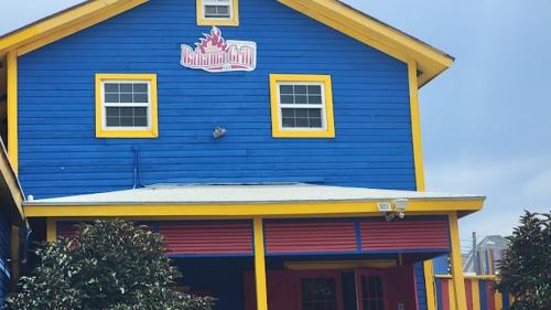 a blue building with a sign on top of it at Ocean Breeze Villa 242 in Nassau