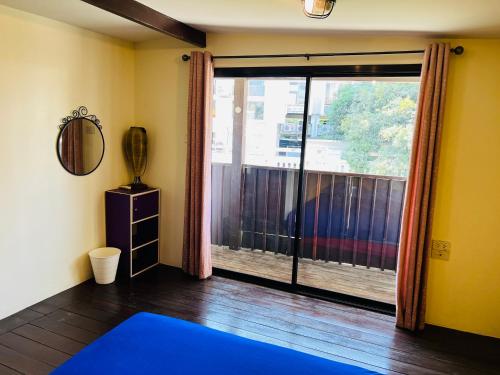 a room with a large window with a blue yoga mat at 146 Canal in Bangkok