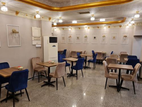 a dining room with tables and blue chairs at Hamit Hotel Istanbul in Istanbul