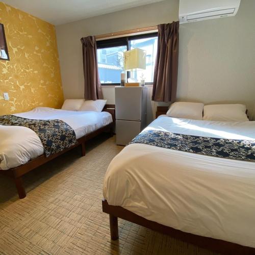 Ένα ή περισσότερα κρεβάτια σε δωμάτιο στο Guest House One More Heart at Kyoto Station South 6