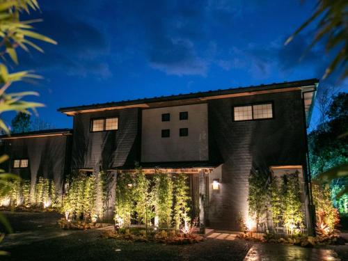 a house decorated with christmas lights at night at Bettei Fujiya in Miyajima
