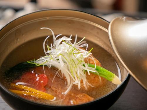 a bowl of soup with vegetables and noodles at Bettei Fujiya in Miyajima