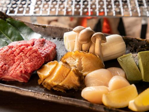 a plate of food with meat and vegetables on it at Bettei Fujiya in Miyajima