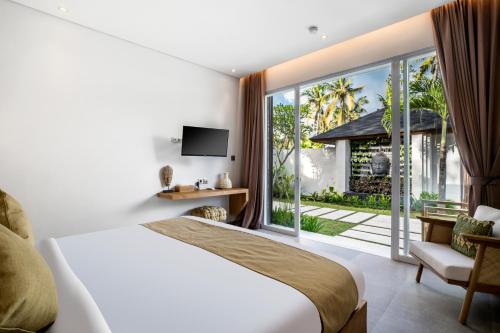 a bedroom with a bed and a large window at Villa Markandeya by BaliSuperHost in Ubud