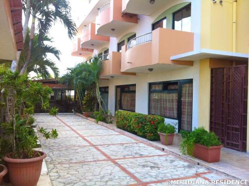 a building with a walkway in front of it at Residence Meridiana in Juan Dolio