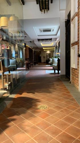 a large room with a tile floor in a building at Hotel Thamel House - 6 km from Boudhanath Stupa, Kathmandu in Kathmandu