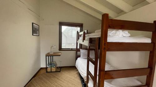 two bunk beds in a room with a window at Alpine Retreat in Dinner Plain