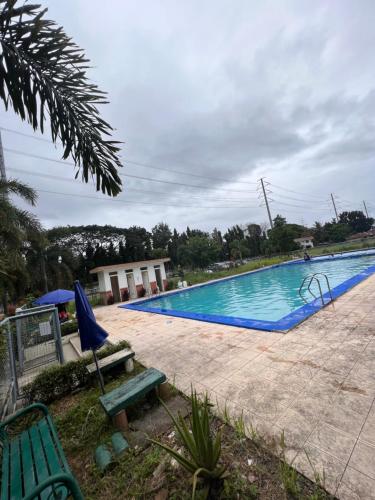 a large swimming pool with a green bench next to it at Dream Condo in Santa Rosa in Santa Rosa