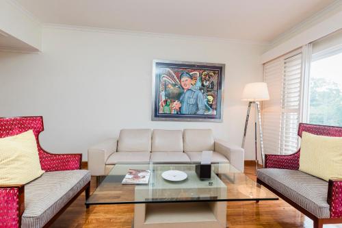 a living room with a couch and a table at Airways Hotel in Port Moresby