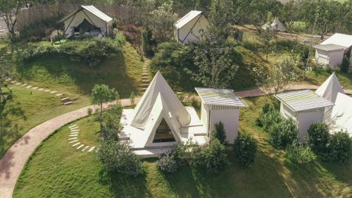 an overhead view of a house on a green field at SOL Glamping at Khao yai in Ban Nong Makha