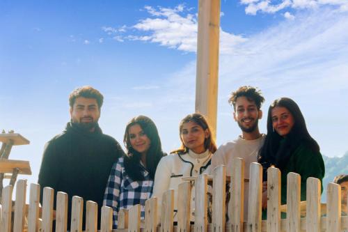a group of people standing behind a wooden fence at Veda Inn in Chakrāta