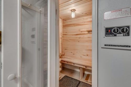 a sauna with a wooden wall and a door at Cozy Home with Sauna in Glenwood Springs in Glenwood Springs