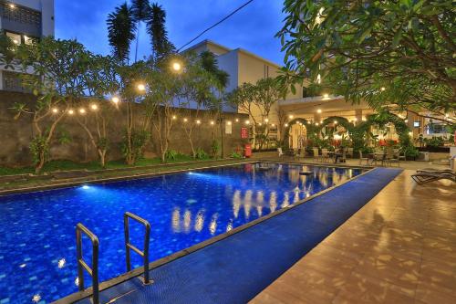 a pool in the middle of a building at night at Riss Hotel Malioboro in Yogyakarta