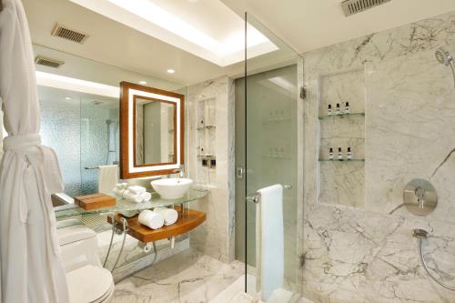 a bathroom with a shower and a toilet and a sink at Hyatt Regency Delhi in New Delhi