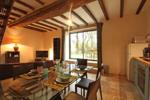 une cuisine et une salle à manger avec une table et des chaises dans l'établissement Marguerite, à Colombiers