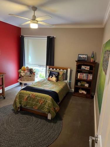a bedroom with a bed and a window at Quiet family retreat getaway - Wildlife Park, Sovereign Hill, Kryall Castle and city at your door - modern house, 8 guests, 4 bedrooms, 5 beds in Ballarat