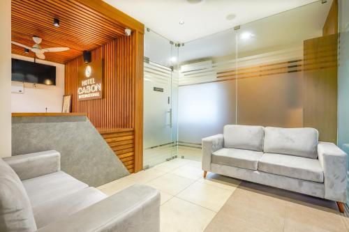 a living room with a couch and a chair at HOTEL CASON INTERNATIONAL in Kondotti