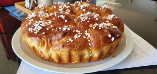 two donuts on a white plate on a table at La Bohème in La Paix