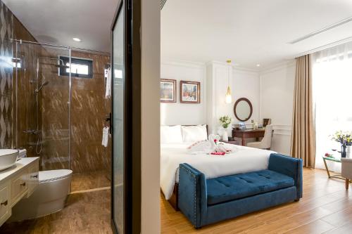 a hotel room with a bed and a bathroom at Menora Grand Da Nang in Da Nang