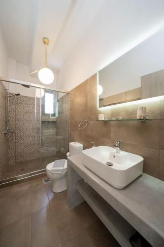 a bathroom with a sink and a toilet and a shower at Luxury Villa Majore in Svoronata