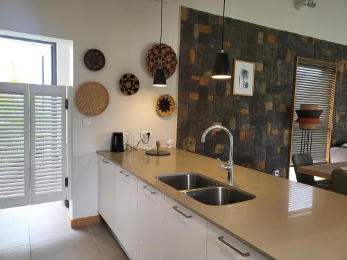 a kitchen with a sink and a counter top at Villa de Luxe à Grand Baie avec piscine V12 in Grand Baie