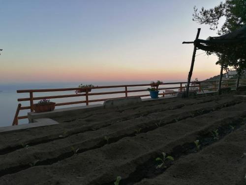 a set of stairs with a sunset in the background at San Giacomo Relais in Furore