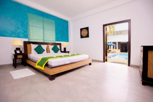 a bedroom with a bed and a pool at St.Lachlan Hotel & Suites in Negombo