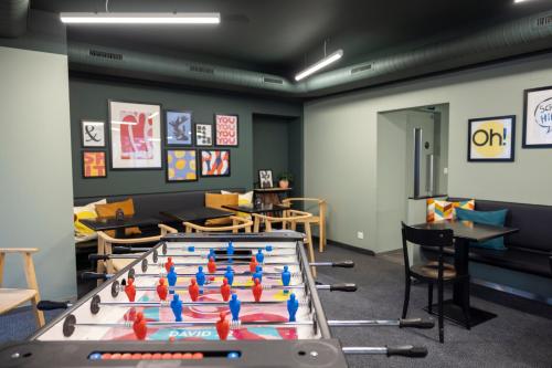 a play room with a ping pong table at Self Check-In Hotel David 22 in St. Gallen