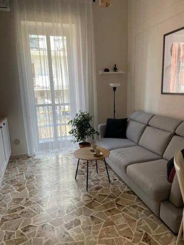 a living room with a couch and a table at Two Balcony Central Bari in Bari