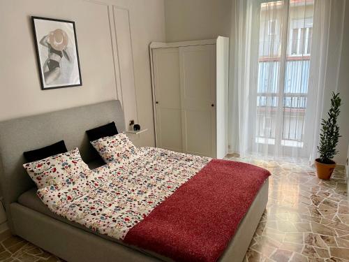 a bedroom with a bed with a red blanket at Two Balcony Central Bari in Bari