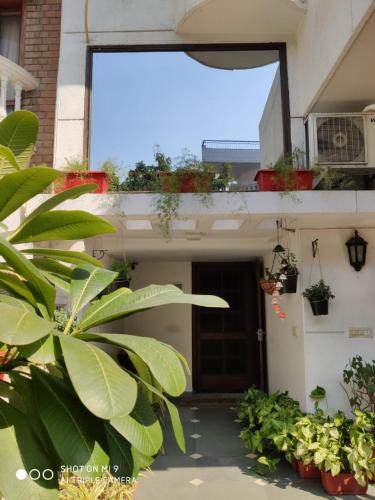a front door of a house with potted plants at The Neem in New Delhi