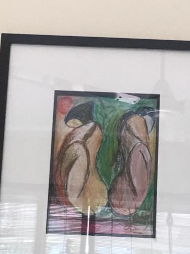 a painting in a frame on top of a window at The Neem in New Delhi
