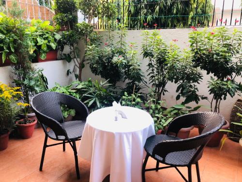 a table and chairs with a white table cloth on it at The Neem in New Delhi