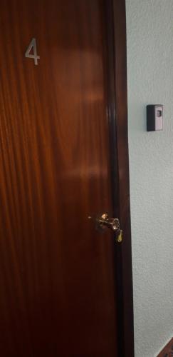 a wooden door with a number four on it at Pensión Benavente AP-7 3min coche Playa 5 min Self check-in 24h in Moncófar