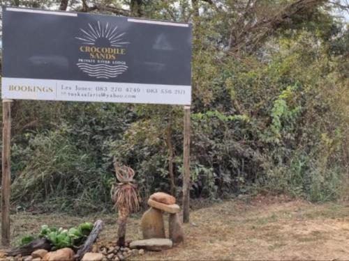 a sign in front of a sign with fruits and vegetables at Crocodile Sands River Lodge in Nelspruit